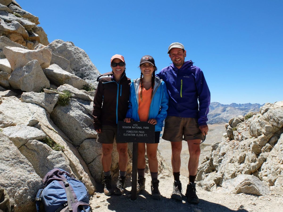 Debbie North and her husband and daughter stand by the Forester Pass sigh on the John Muir Trail