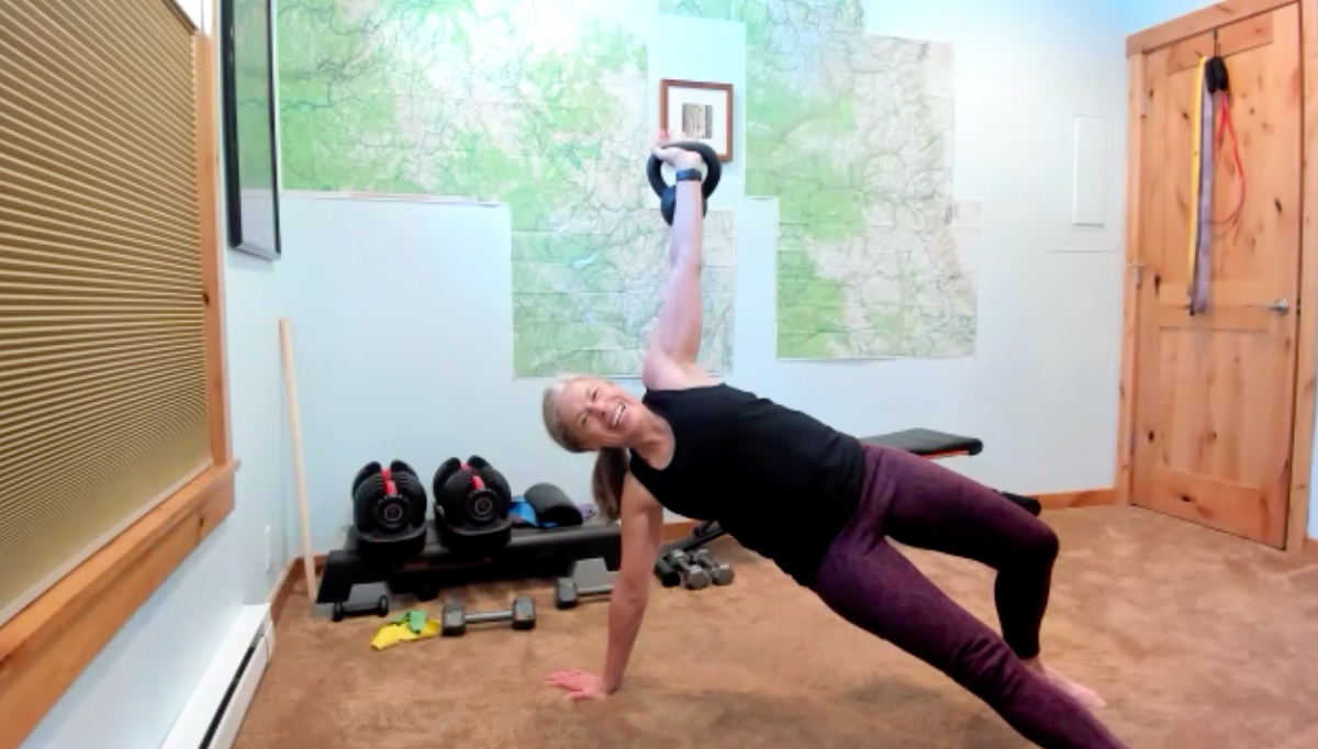 woman strength training at home with a kettlebell